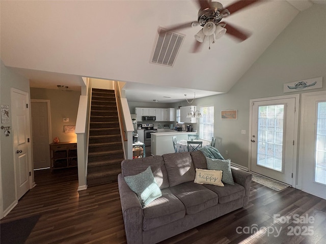 living area featuring stairway, dark wood-style floors, ceiling fan, and visible vents