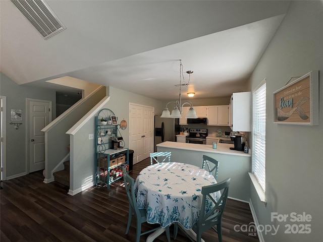 dining space featuring stairway, visible vents, baseboards, and dark wood-style flooring