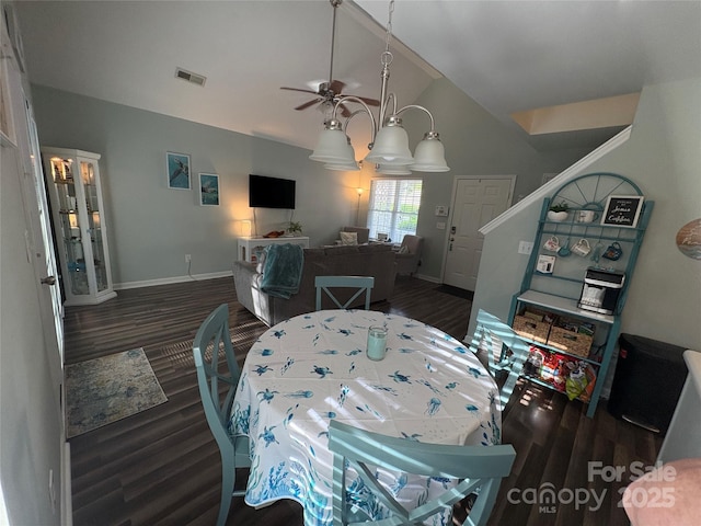 dining room featuring baseboards, visible vents, lofted ceiling, wood finished floors, and ceiling fan
