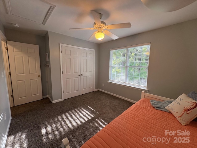 bedroom with a closet, carpet flooring, baseboards, and a ceiling fan