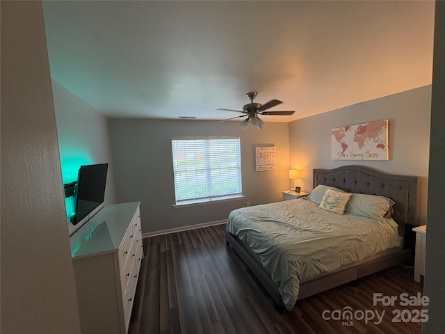 bedroom with baseboards, dark wood-style floors, and ceiling fan