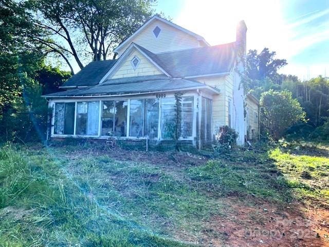 6000 S Main St, Salisbury, NC 28147 - view of front facade featuring a sunroom and a chimney