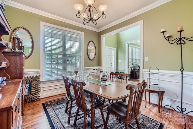 10836 Maryanna Ct, Charlotte, NC 28213 - dining space with light wood-style floors, wainscoting, crown molding, and a wealth of natural light