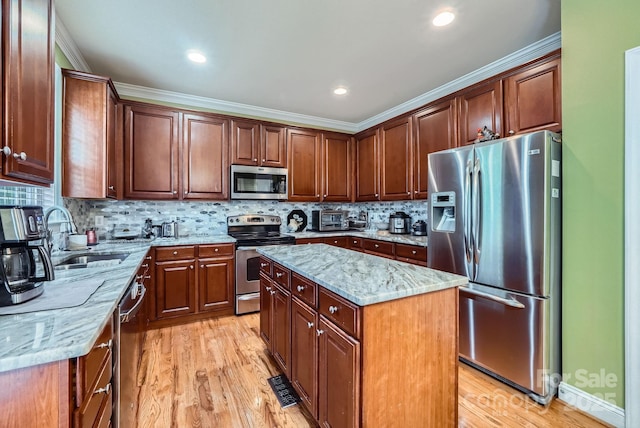 10836 Maryanna Ct, Charlotte, NC 28213 - kitchen with light stone counters, a sink, light wood finished floors, stainless steel appliances, and tasteful backsplash