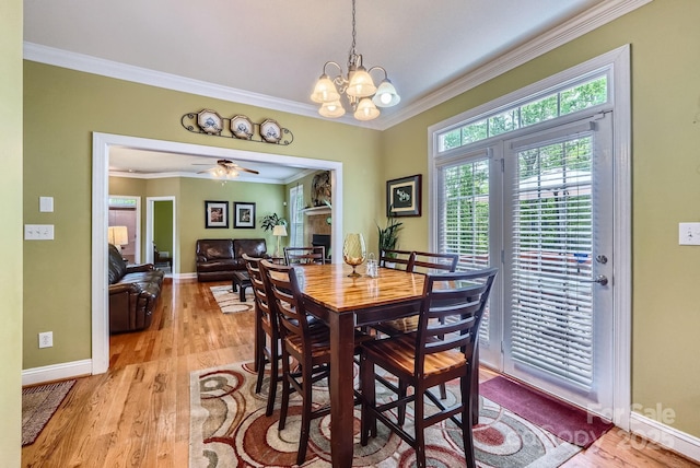 10836 Maryanna Ct, Charlotte, NC 28213 - dining room featuring crown molding, baseboards, a chandelier, and light wood-style floors