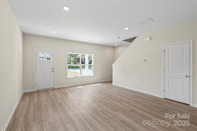 808 Carolyn Ave, Kannapolis, NC 28083 - unfurnished living room with light wood finished floors, baseboards, and recessed lighting
