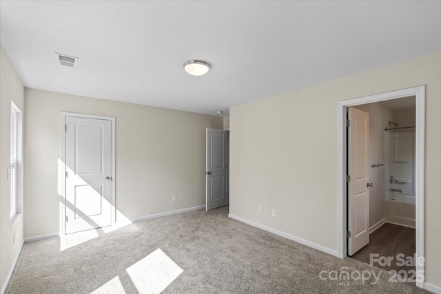 808 Carolyn Ave, Kannapolis, NC 28083 - unfurnished bedroom featuring carpet, visible vents, and baseboards