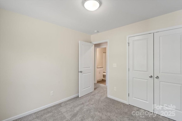 808 Carolyn Ave, Kannapolis, NC 28083 - unfurnished bedroom featuring a closet, baseboards, and light colored carpet