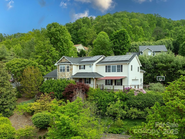 106 Thistle Tree Way, Weaverville, NC 28787 - view of front facade featuring solar panels and a forest view