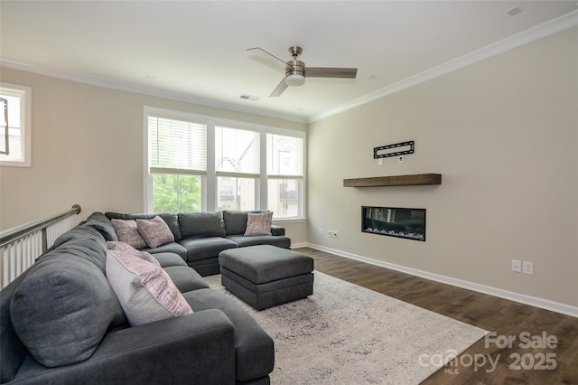 604 Tudor Park Way, Charlotte, NC 28211 - living room featuring visible vents, a ceiling fan, ornamental molding, dark wood-type flooring, and a glass covered fireplace