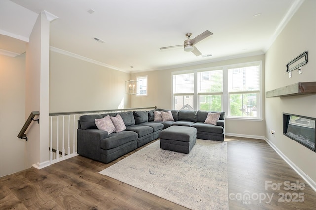 604 Tudor Park Way, Charlotte, NC 28211 - living area featuring plenty of natural light, a glass covered fireplace, ornamental molding, and dark wood finished floors