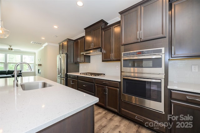 604 Tudor Park Way, Charlotte, NC 28211 - kitchen with recessed lighting, under cabinet range hood, stainless steel appliances, a sink, and crown molding