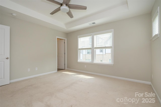 604 Tudor Park Way, Charlotte, NC 28211 - unfurnished bedroom with multiple windows, light carpet, visible vents, and a tray ceiling