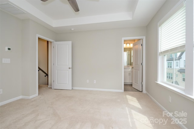 604 Tudor Park Way, Charlotte, NC 28211 - unfurnished bedroom featuring light colored carpet, baseboards, a tray ceiling, and visible vents