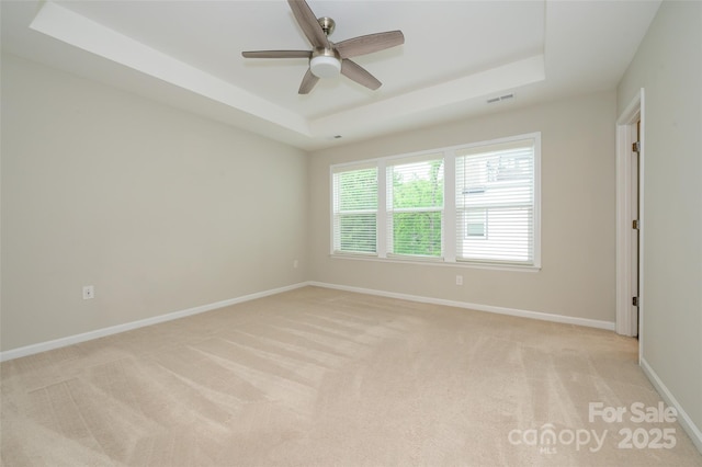 604 Tudor Park Way, Charlotte, NC 28211 - empty room featuring a raised ceiling, visible vents, light carpet, baseboards, and ceiling fan
