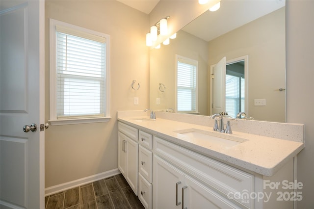 604 Tudor Park Way, Charlotte, NC 28211 - bathroom featuring baseboards, wood finished floors, a sink, and double vanity