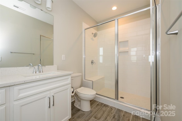 604 Tudor Park Way, Charlotte, NC 28211 - bathroom featuring wood finished floors, visible vents, toilet, vanity, and a stall shower
