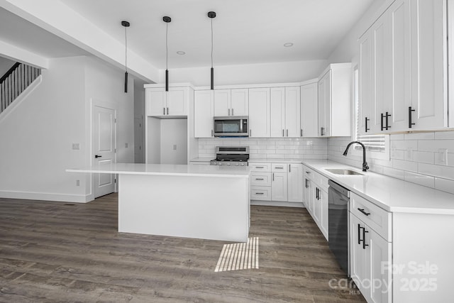 kitchen with a sink, white cabinetry, light countertops, backsplash, and appliances with stainless steel finishes