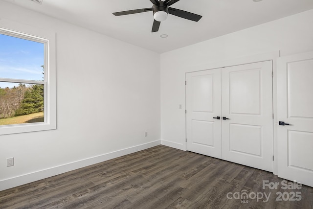unfurnished bedroom with a ceiling fan, a closet, baseboards, dark wood-style floors, and recessed lighting