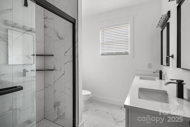 bathroom featuring marble finish floor, toilet, a sink, and a marble finish shower