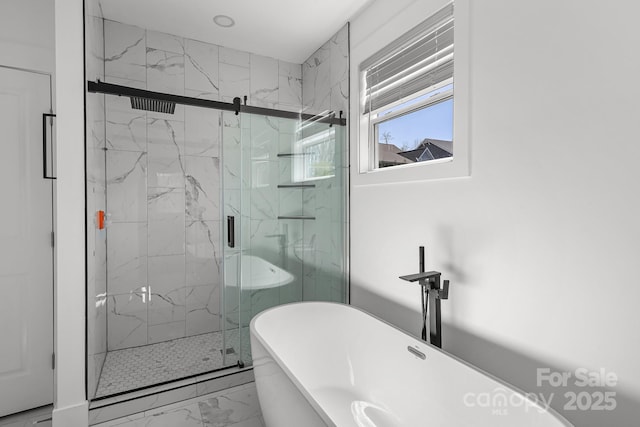 full bathroom featuring a soaking tub, marble finish floor, and a marble finish shower