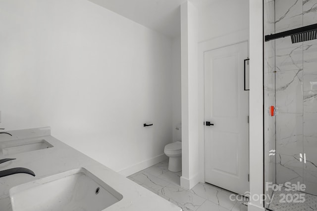 bathroom featuring a marble finish shower, marble finish floor, toilet, and a sink