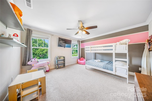 carpeted bedroom with multiple windows, ceiling fan, and baseboards