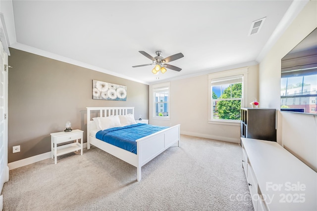 bedroom with carpet, crown molding, baseboards, and ceiling fan