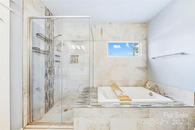 full bath featuring a garden tub and a stall shower