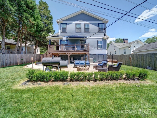 rear view of property featuring an outdoor living space with a fire pit, a patio, and a deck