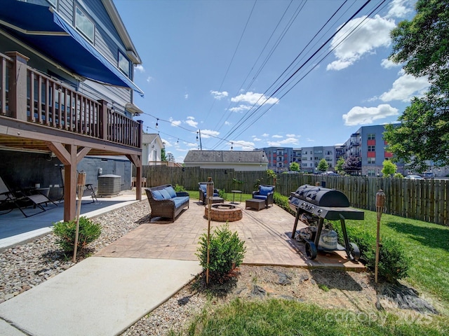 view of patio / terrace featuring an outdoor fire pit, cooling unit, area for grilling, and a fenced backyard
