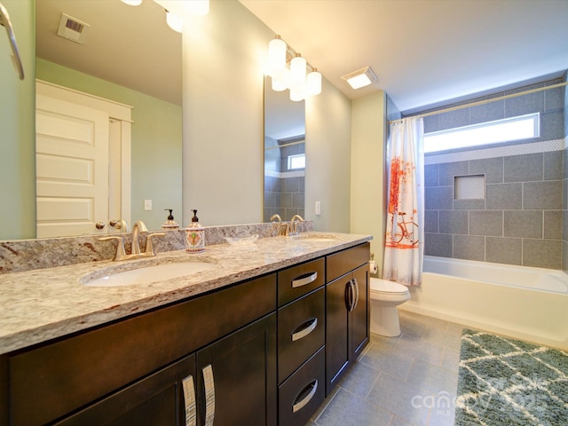 bathroom featuring toilet, shower / tub combo with curtain, double vanity, and tile patterned flooring