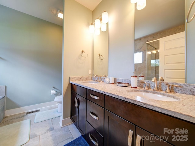full bathroom with a stall shower, toilet, double vanity, tile patterned flooring, and baseboards