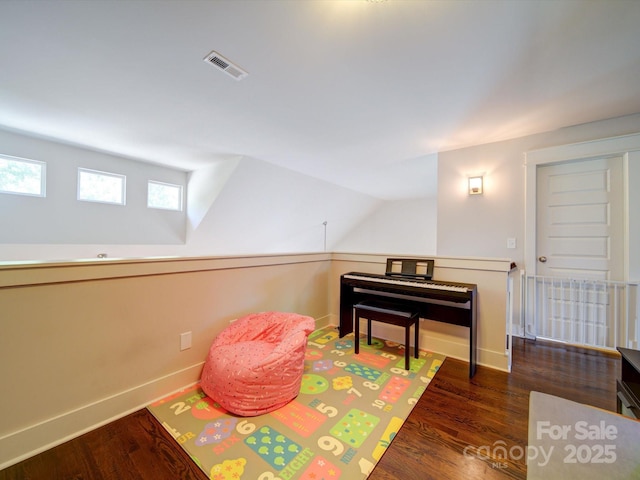 game room featuring wood finished floors, baseboards, and lofted ceiling