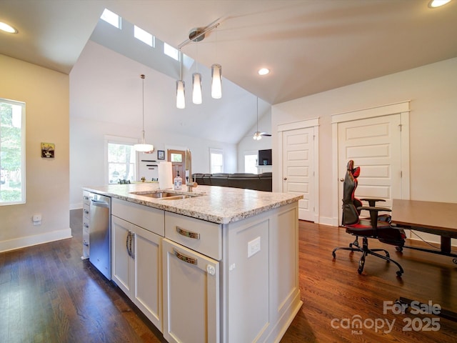 kitchen featuring lofted ceiling, stainless steel dishwasher, white cabinetry, dark wood-style floors, and hanging light fixtures