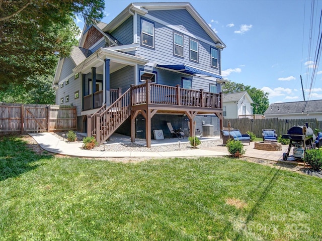 back of property featuring a wooden deck, a patio, an outdoor fire pit, stairway, and central air condition unit