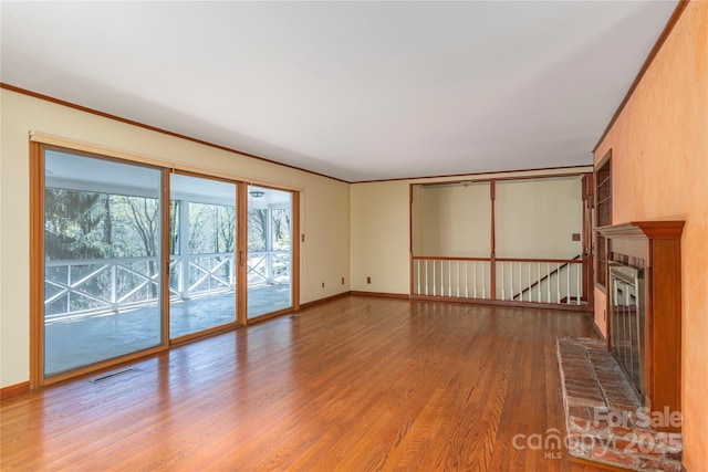 220 Ridge Rd, Waynesville, NC 28786 - unfurnished living room with a brick fireplace and wood finished floors