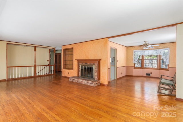 220 Ridge Rd, Waynesville, NC 28786 - unfurnished living room featuring wood finished floors, a fireplace, and a ceiling fan