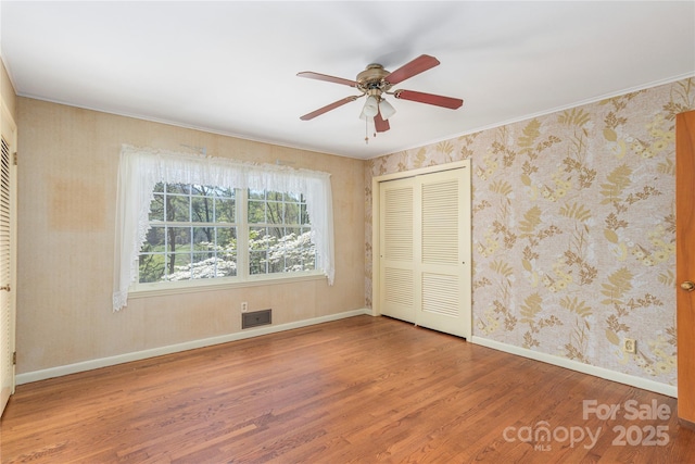 220 Ridge Rd, Waynesville, NC 28786 - unfurnished bedroom with wood finished floors, a closet, and ceiling fan