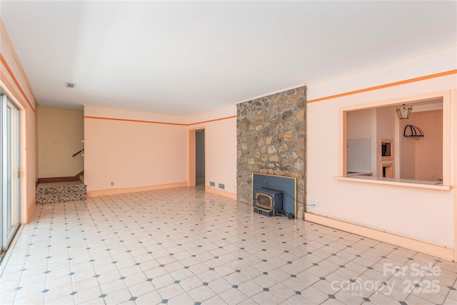 220 Ridge Rd, Waynesville, NC 28786 - unfurnished living room with a wood stove, stairs, and tile patterned floors