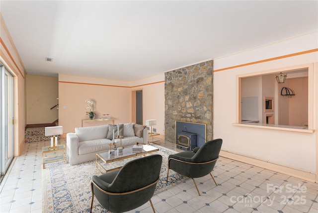 220 Ridge Rd, Waynesville, NC 28786 - living area featuring a wood stove, stairway, and tile patterned floors