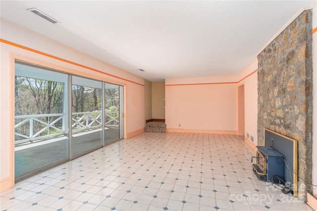 220 Ridge Rd, Waynesville, NC 28786 - unfurnished living room featuring a wood stove and baseboards