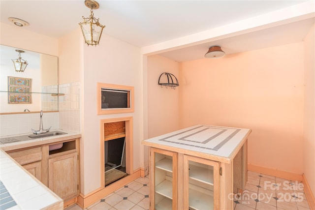 220 Ridge Rd, Waynesville, NC 28786 - kitchen featuring tile countertops, backsplash, light brown cabinetry, pendant lighting, and light tile patterned floors
