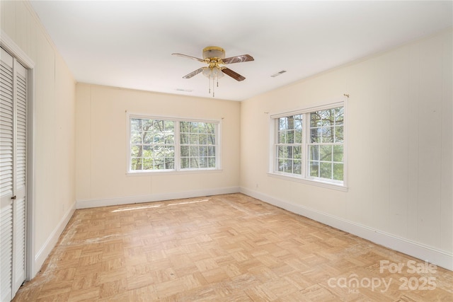 220 Ridge Rd, Waynesville, NC 28786 - unfurnished bedroom featuring multiple windows, a closet, and a ceiling fan