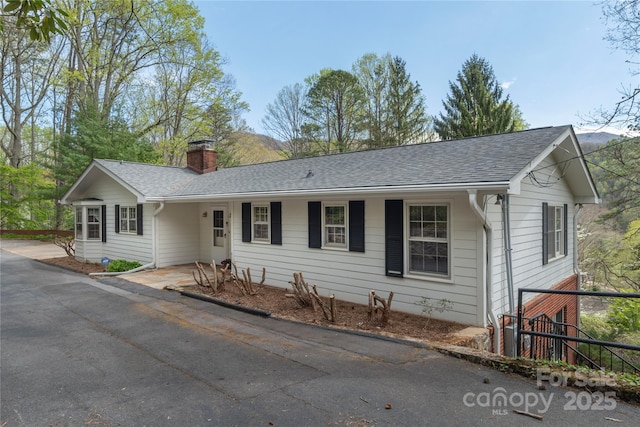 220 Ridge Rd, Waynesville, NC 28786 - ranch-style home featuring a chimney, roof with shingles, and asphalt driveway