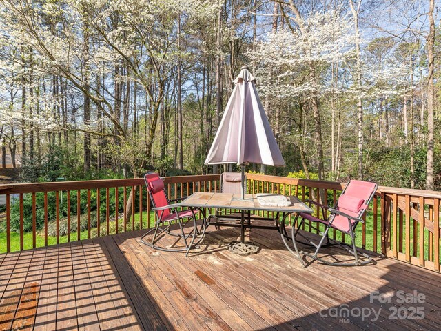 wooden deck with outdoor dining area