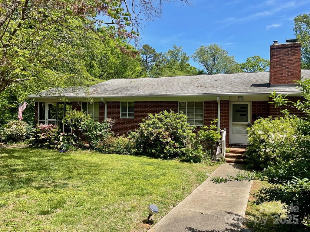 3100 Ventosa Dr, Charlotte, NC 28205 - single story home featuring a chimney, brick siding, and a front yard