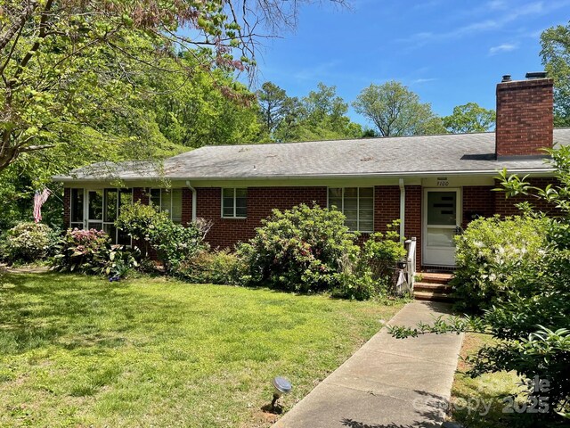 3100 Ventosa Dr, Charlotte, NC 28205 - single story home featuring a chimney, brick siding, and a front yard