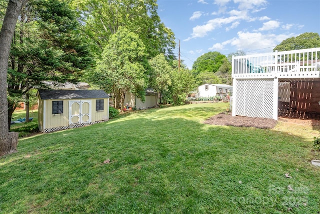 view of yard featuring an outbuilding, a deck, and a storage shed