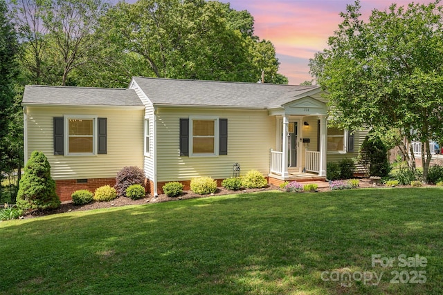ranch-style home with a shingled roof, a front yard, and crawl space